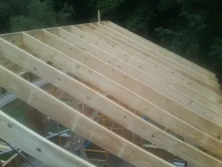New roof rafters set over an addition before sheathing in Beaver Falls