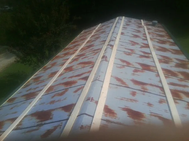 Rusted metal roof panels with new wood purlins before replacement — Storm Damage Roof Repair in Beaver Falls by Roofing Brothers